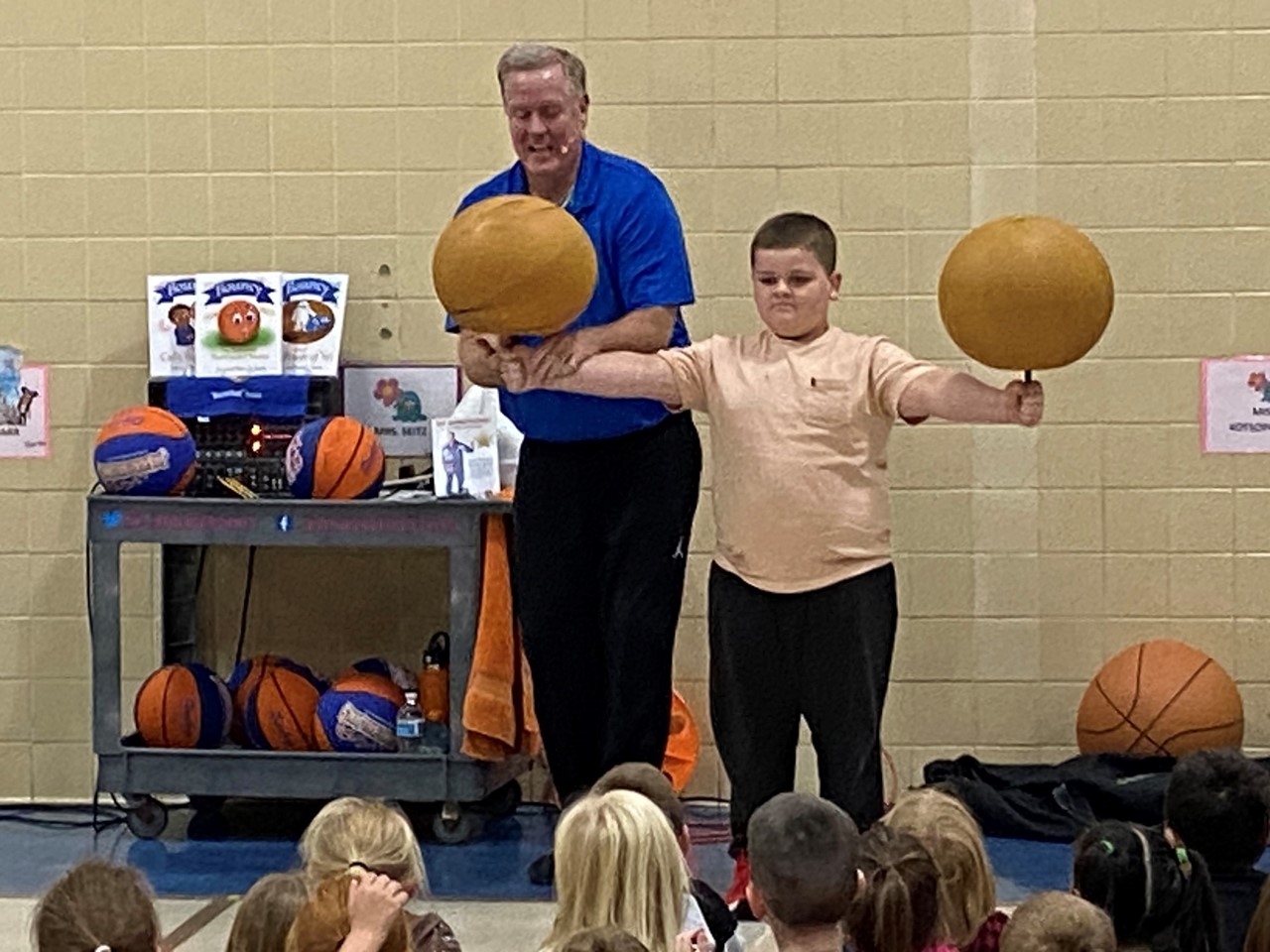 Basketball Jones helps Franklin spin basketballs.