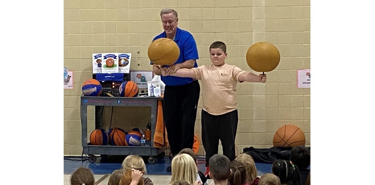 Basketball Jones helps Franklin spin basketballs.